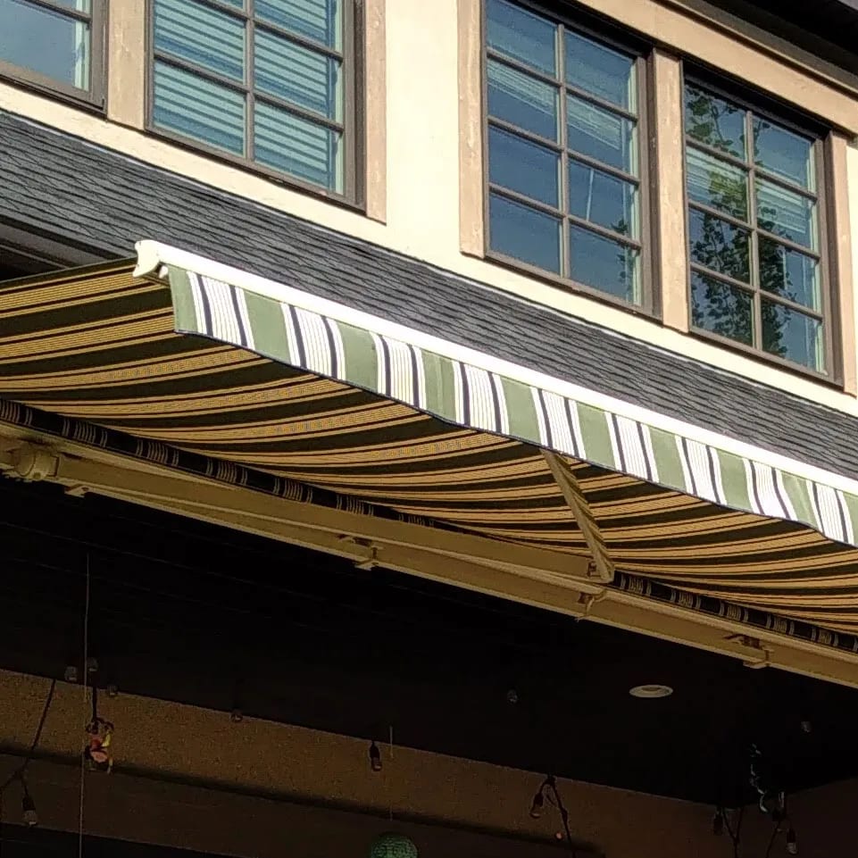 Retractable awning extending over a residential deck
