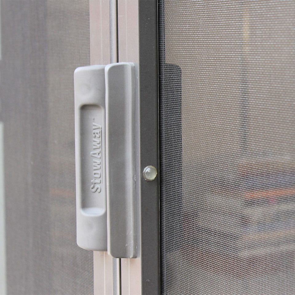 Close view of a retractable door screen handle