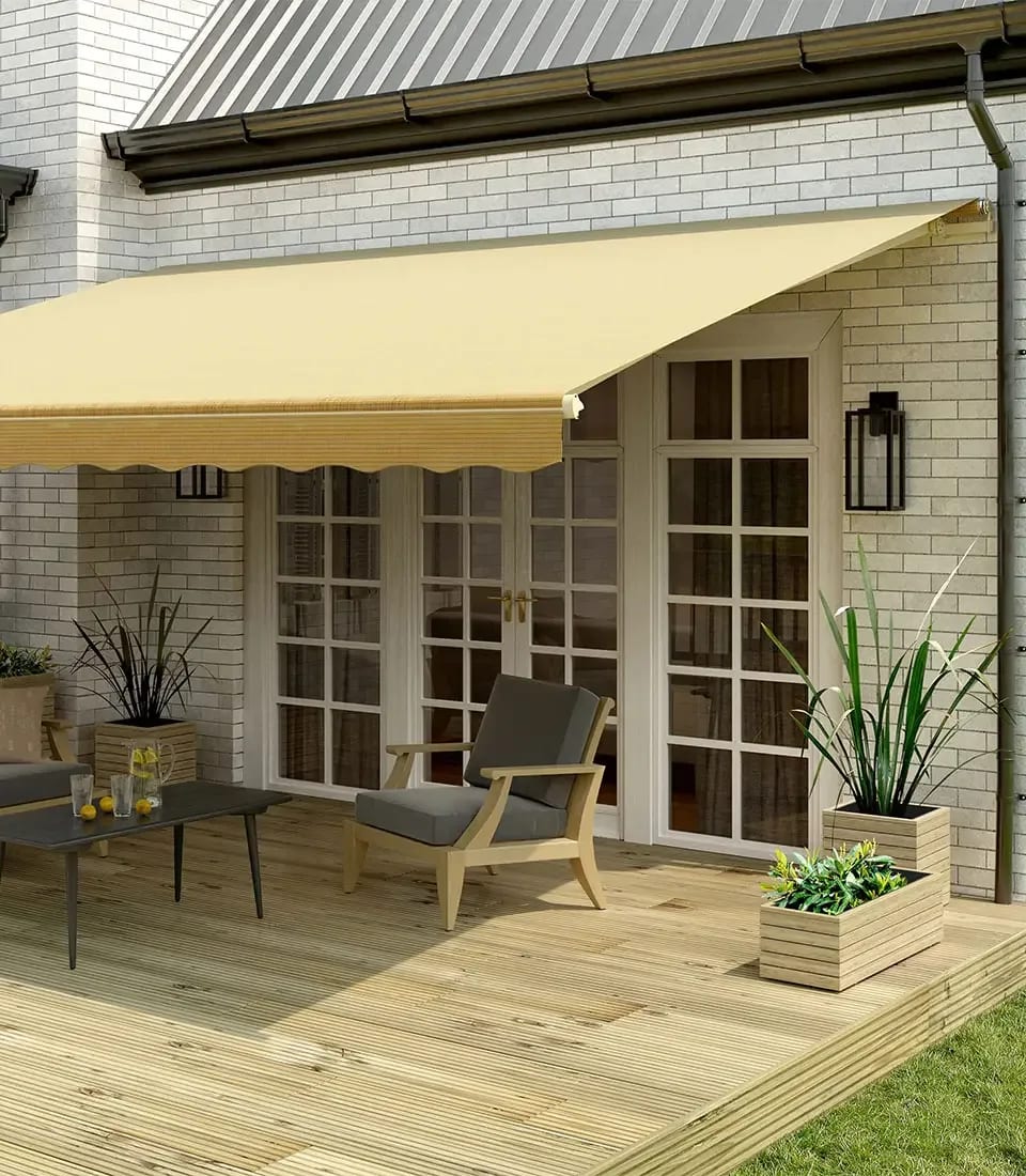 Tan retractable awning covering a backyard patio