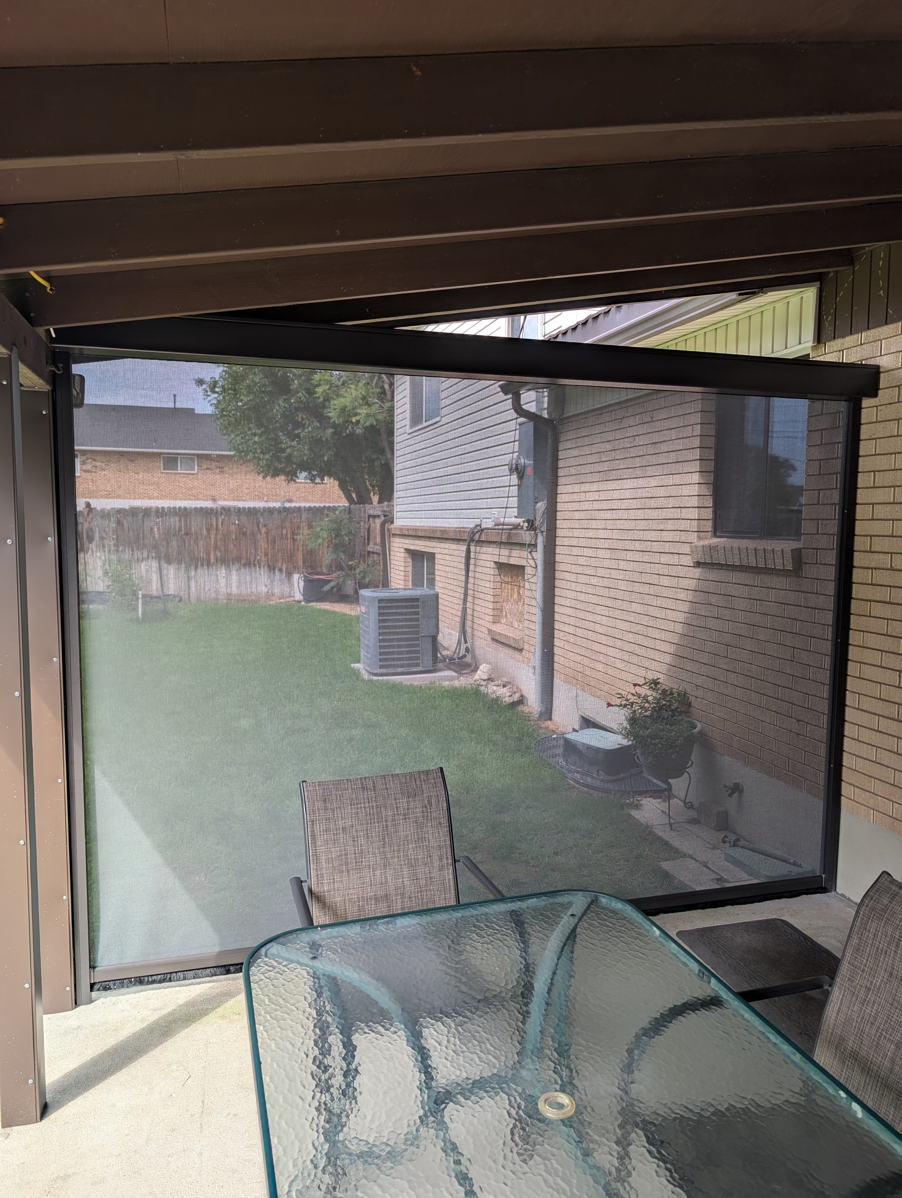 Retractable insect screen viewed from inside a covered Utah patio
