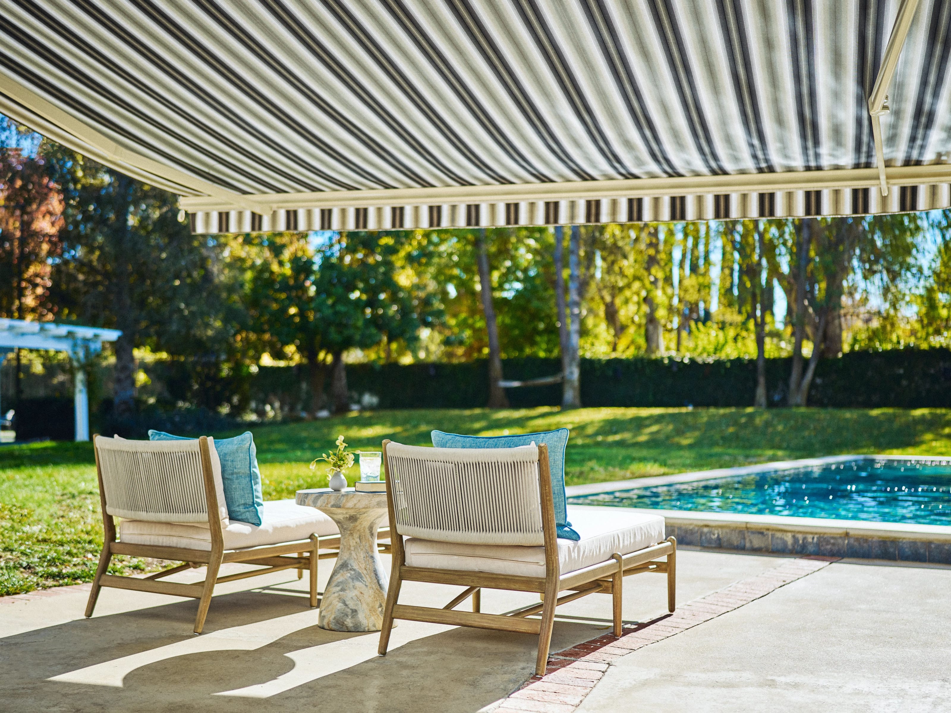 Striped retractable awning extended over a residential patio