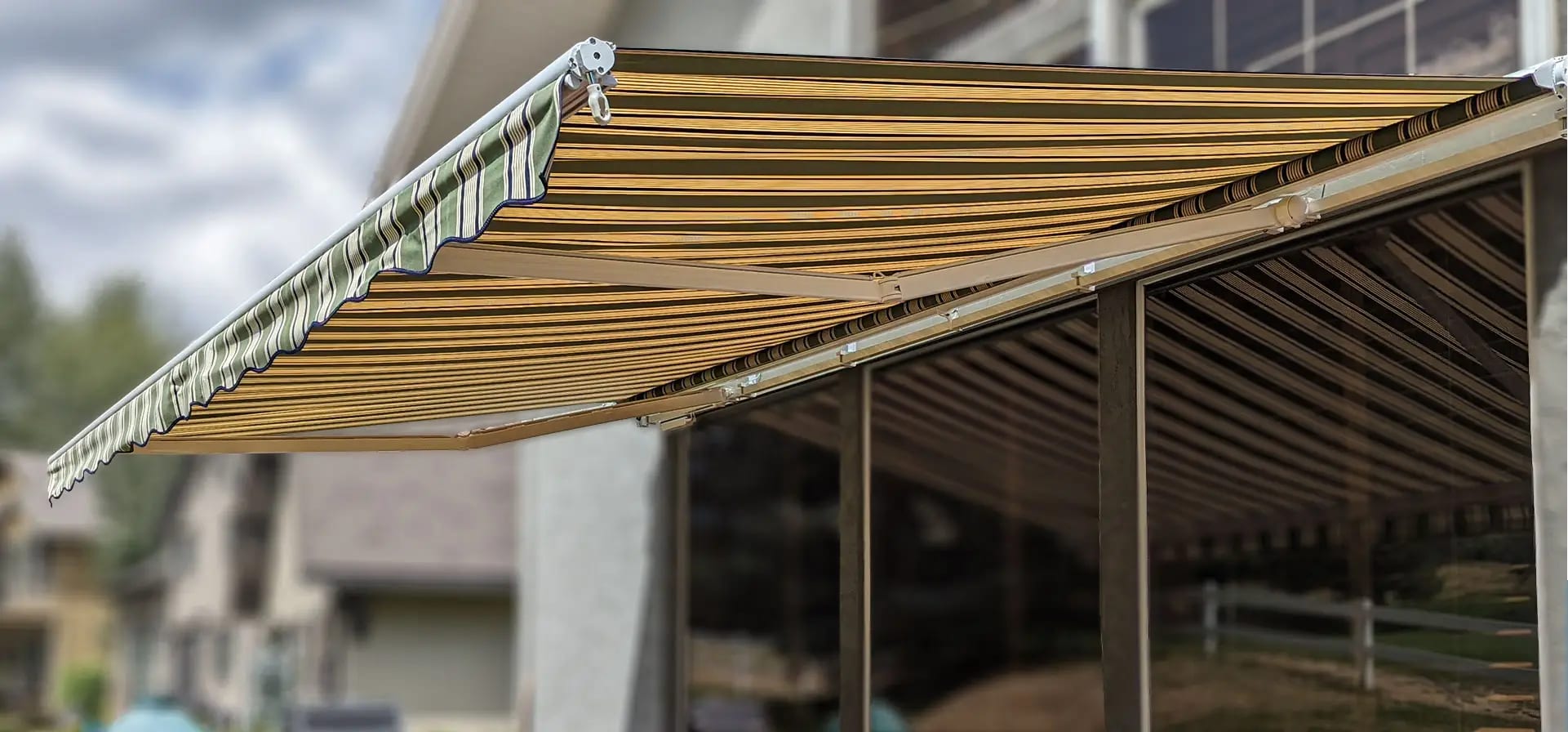 Striped retractable awning extended over a residential patio
